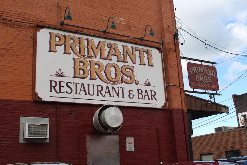 A large Primanti Bros. sign located on the side of their Strip District location. Photo by Kyra Moore, 2019
